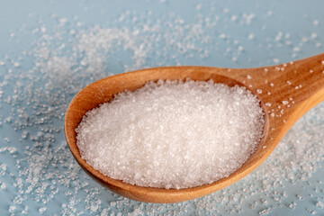 Granulated sugar in a spoon, detail macro photography of the granules