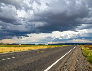 Dramatic Landscape with Open Road under Dark Cloudy Sky
