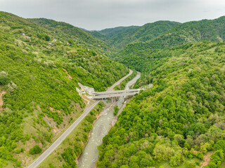 Aerial view of a quiet highway passing through a tunnels in a picturesque hilly region Rikoti Pass