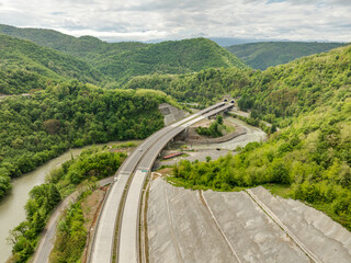 Aerial view of a quiet highway passing through a tunnels in a picturesque hilly region Rikoti Pass