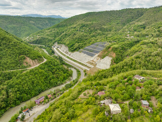 Aerial view of a quiet highway passing through a tunnels in a picturesque hilly region Rikoti Pass
