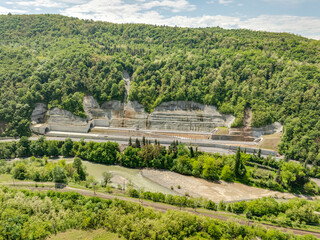 Aerial view of a quiet highway passing through a tunnels in a picturesque hilly region Rikoti Pass