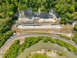 Aerial view of a quiet highway passing through a tunnels in a picturesque hilly region Rikoti Pass