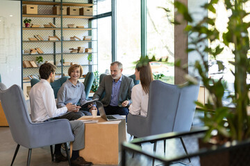 Group of happy progressive business people working on startup together at creative office