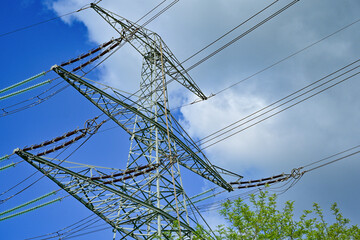 Power poles in spring on the field and meadow, Brandenburg, Germany