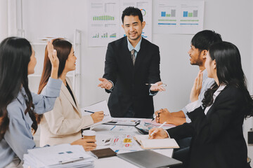 Team of financial advisory services. Asian advisor showing plan of investment to clients in the consultancy office..