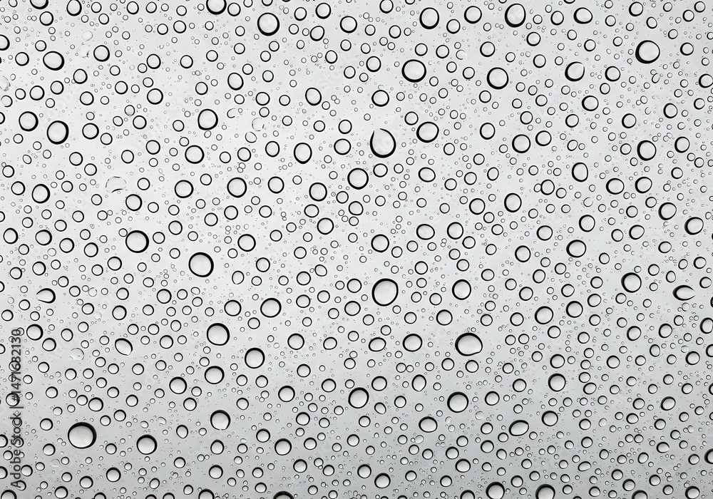 Poster close-up view of numerous water droplets clinging to a clear surface creating an abstract pattern