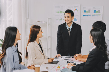 Team of financial advisory services. Asian advisor showing plan of investment to clients in the consultancy office..