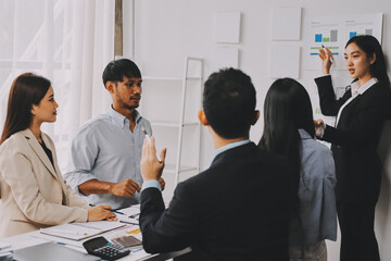 Team of financial advisory services. Asian advisor showing plan of investment to clients in the consultancy office..