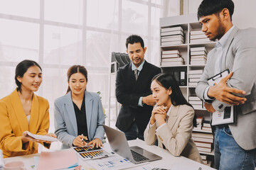 Team of financial advisory services. Asian advisor showing plan of investment to clients in the consultancy office..