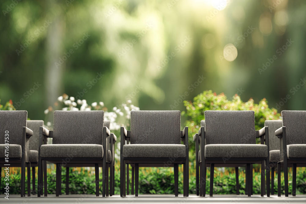 Aufkleber row of gray fabric chairs, dark frames, set against blurred green garden backgroundshowcase for prod