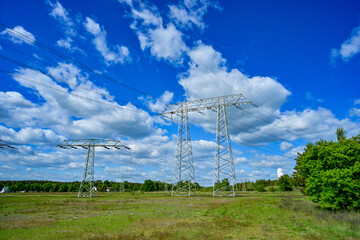 Power poles in spring on the field and meadow, Brandenburg, Germany