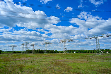 Power poles in spring on the field and meadow, Brandenburg, Germany