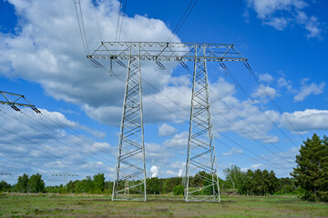 Power poles in spring on the field and meadow, Brandenburg, Germany