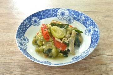 spicy stir fried slice long green eggplant with pork and basil on plate 