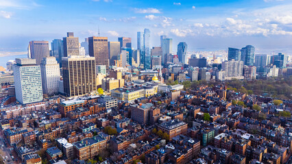 Fototapeta premium Orange brick houses along stunning skyscrapers. Varied scenery of Boston, Massachusetts, USA. Aerial view.