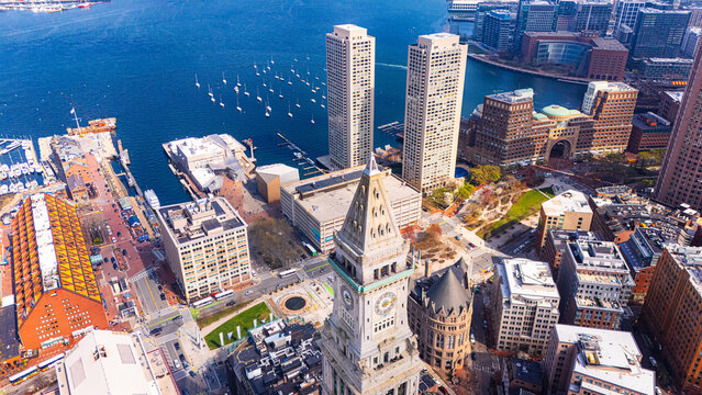 Two similar Harbor towers in Boston, Massachusetts, USA. City tallest buildings at the backdrop of blue waterscape. Aerial view.
