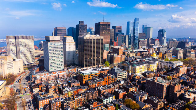 Orange brick houses along stunning skyscrapers. Varied scenery of Boston, Massachusetts, USA. Aerial view.