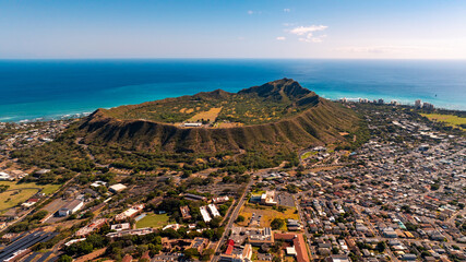 Diamond Head Crater surrounded by a modern lively cityscape. Beautiful azure waterscape at backdrop. Aerial view. © Vadim