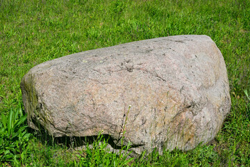 Stone, boulder, in a meadow,