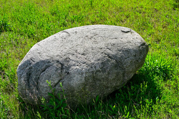 Stone, boulder, in a meadow,