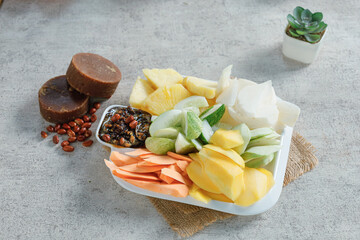 Sliced mango, cucumber, papaya, ginger and wasabi