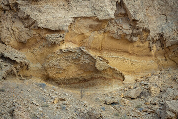 A close-up view of ancient desert rocks in Sharjah showing visible sediment layers formed over millions of years through erosion and tectonic activity