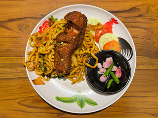 Malaysian indian spicy curry noodle with seasoned fried chicken and shallots. Southeast asian...