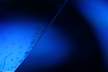 Deep blue liquid surface on black background, oil stains movement, bright chemistry, surreal...