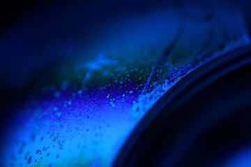 Deep blue liquid surface on black background, oil stains movement, bright chemistry, surreal background, blue sky colour, flat panels