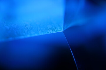 Deep blue liquid surface on black background, oil stains movement, bright chemistry, surreal...