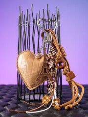 close up of brown bag trim, heart shaped keychains, eiffel tower keychains and beaded cord