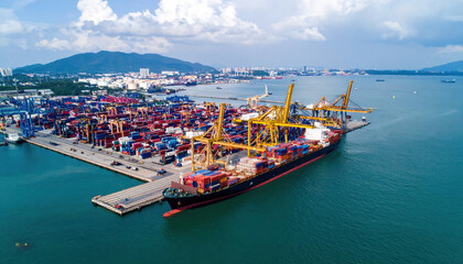 Fototapeta premium Aerial View of Busy Shipping Port with Container Ship and Cranes