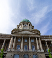 Low angle view of Buda Castle dome and classical architecture in Budapest under blue sky