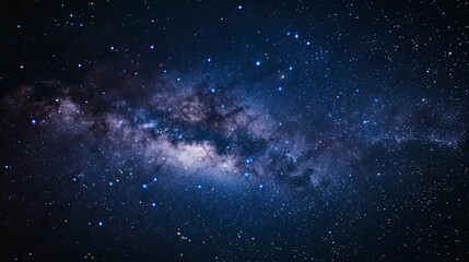 Fototapeta premium Milky Way galaxy stretches across a star-studded night sky
