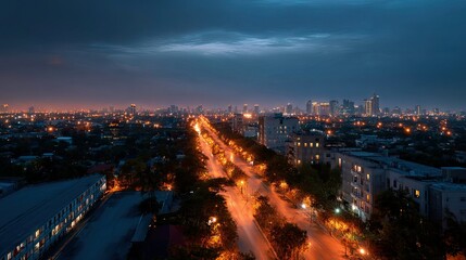 Fototapeta premium Beautiful panoramic shot of a city illuminated by thousands of street lights at night, with the glow of buildings creating a captivating skyline