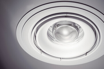 Obraz premium ceiling background with a circular cutout for a recessed fire sprinkler, clean white drywall surface, slightly industrial look, optional visible fire sprinkler escutcheon installed in the hole