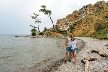 Couple on the shore of Lake Baikal, Olkhon Island. Summer vacation