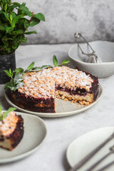 Round Pie with black currants and mint in a plate on the table. Dessert