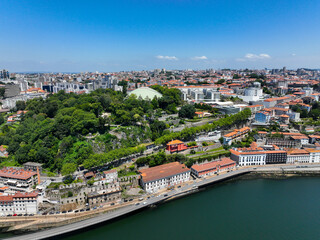 Aerial photo of a tree-covered park with a domed pavilion overlooking river in Porto, Portugal