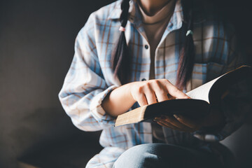 Christian woman reading bible in ancient Catholic temple. Reading Holy Bible in temple. Concept for...