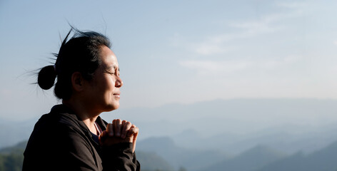 Grateful woman having HOPE praying to God. Spiritual girl smiling to sky. Happy female being thankful. Spiritual girl praying with hope. Positive asian young woman feeling hope and faith looking up.