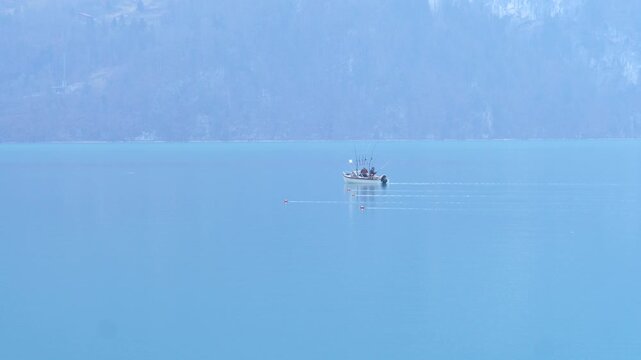 xA view of a small fishing boat on the Brienz lake in winter. Brienz, Switzerland - February 10, 2025. 