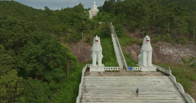 Aerial view Wat Phra That Mae Yen, an ancient temple that has been a symbol of Pai for a long time. Phra Phuttha Lokuttara Mahamuni, a large white Buddha statue in the Mara-Vijaya attitude on hilltop