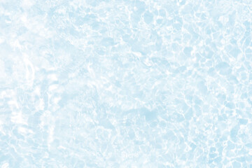 Blue water with ripples on the surface. Defocus blurred transparent blue colored clear calm water surface texture with splashes and bubbles. Water waves with shining pattern texture background.