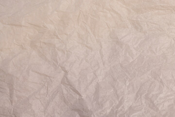 crumpled light-colored wrapping paper after prolonged use