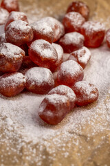 sweet dehydrated candied fruits of kumquat in white powdered, dried fruits are on paper