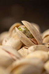 pistachios with green nuts inside, the salted pistachios on the table, close up