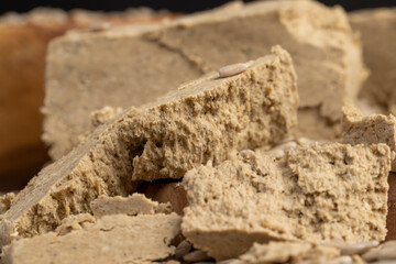 halva from sunflower seeds crushed into one solid mass, a sweet delicious dessert made from fried sunflower seeds, side view