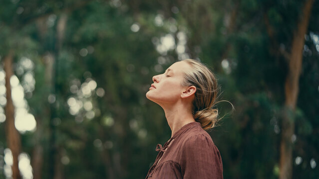 Woman raising her arms and embracing nature
